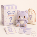 A cute lavender plush cat toy displayed with its branded box, a cream drawstring pouch with a large question mark, a collector card, and a digital keepsake envelope on a warm off-white background.